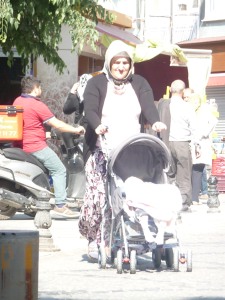 Grandmother pushing baby stroller in Istanbul.